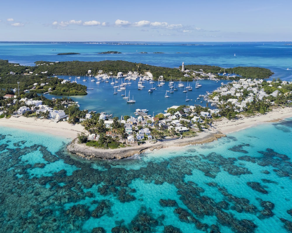 Aerial view of the harbor, beach, and lighthouse in Hope Town on Elbow Cay in the Abacos, Bahamas