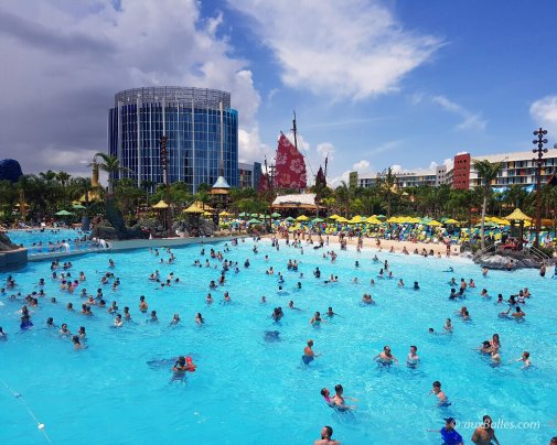 The massive wave pool with its large sandy beach and umbrellas