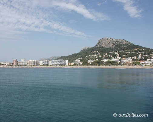 The wide sandy beach of L'Estartit, dominated by the Roca Maura massif